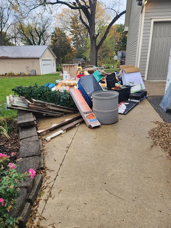 Dumpster being loaded with debris for 3 Yard Dumpster Rental in Clute